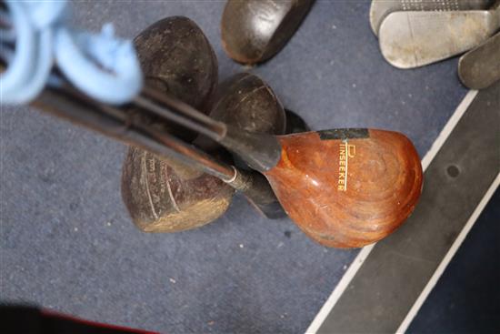 A collection of golf clubs, including woods and irons (makers including Whitcombe and Spalding)